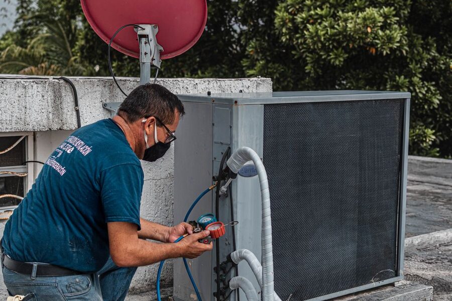 An HVAC technician servicing a unit