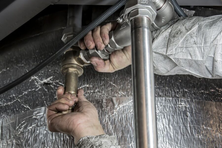 A plumber working on a pipe